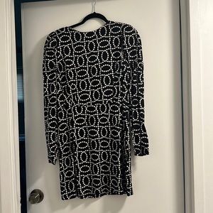 Padded shoulder open back dress.